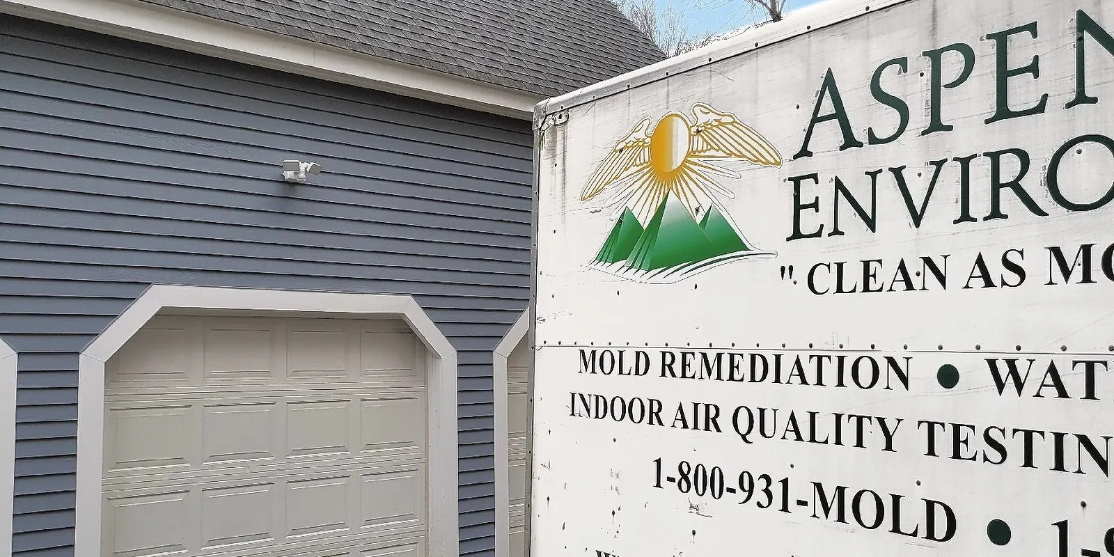 Aspen Environmental trailer parked outside a home